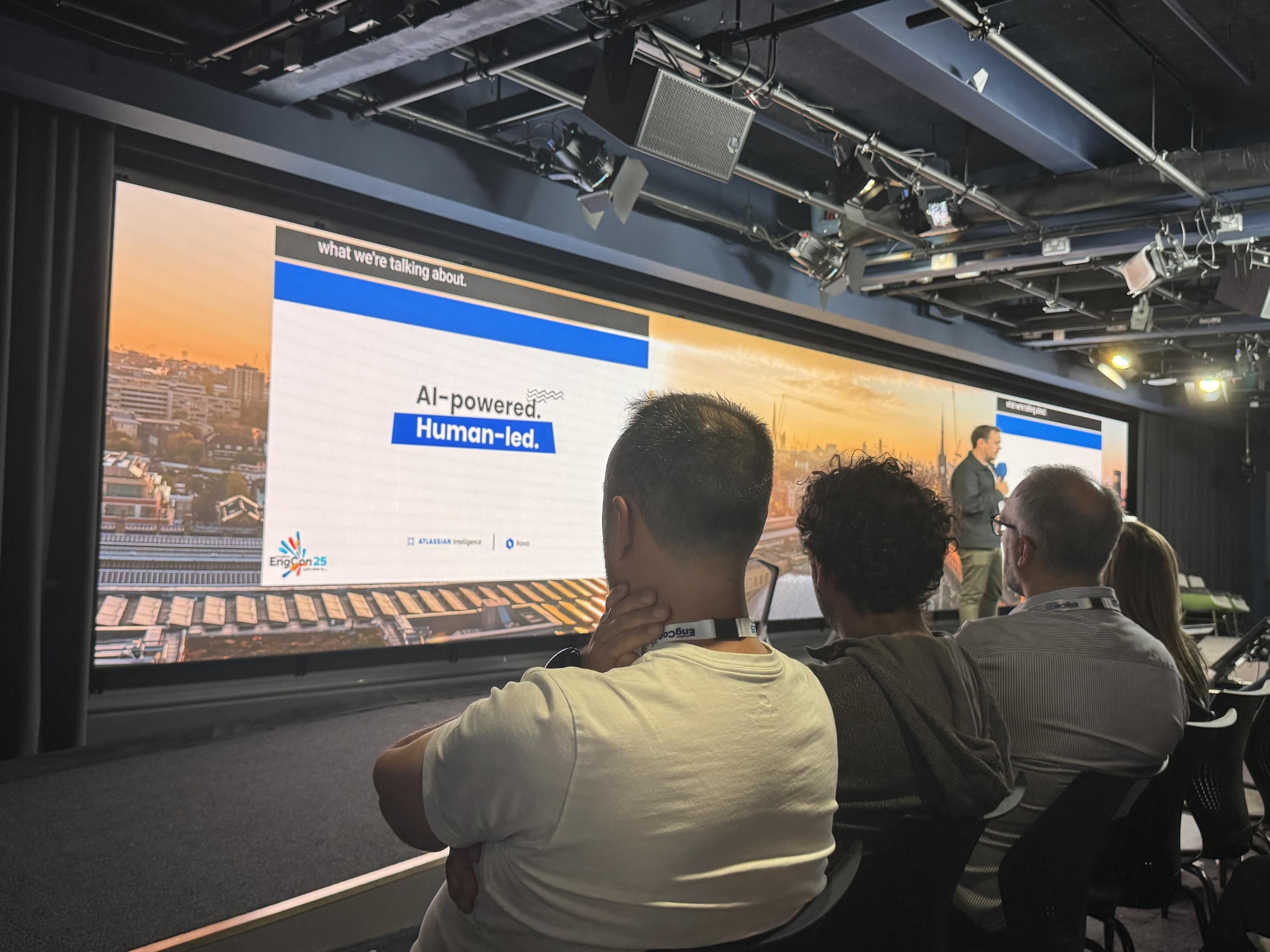 A very wide screen in a conference room